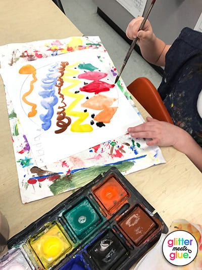 Student tempera painting his dot for International Dot Day