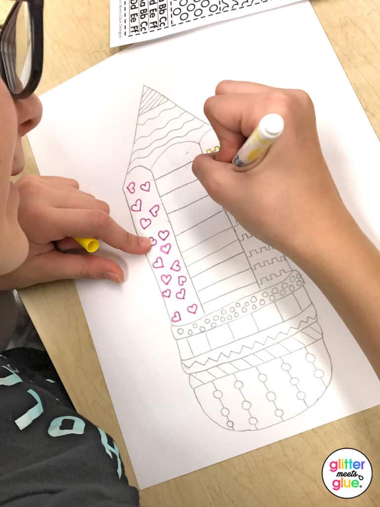 student drawing a pencil