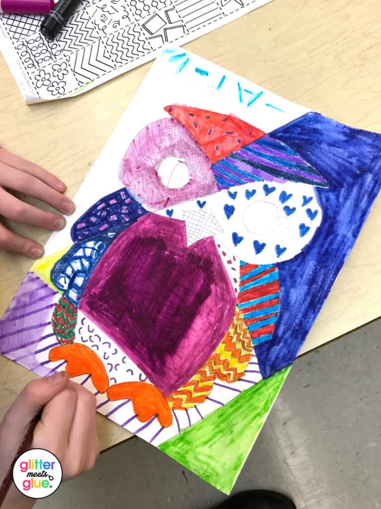 student coloring romero britto picture in art class