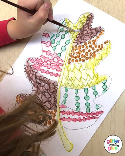 student painting fall leaf with analogous colors
