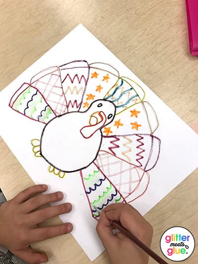 4th grader painting her turkey drawing