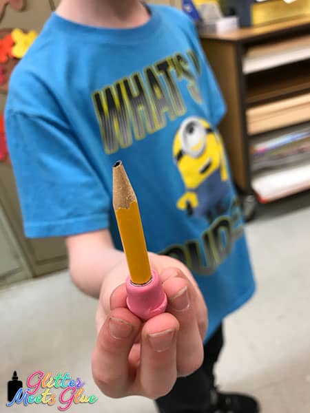 kid holding a pencil stub